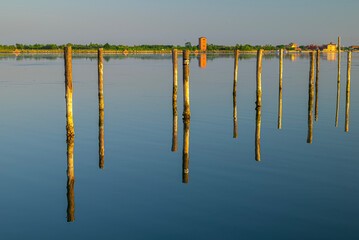 Red House behind Poles in the Venetian Lagoon at Sunset