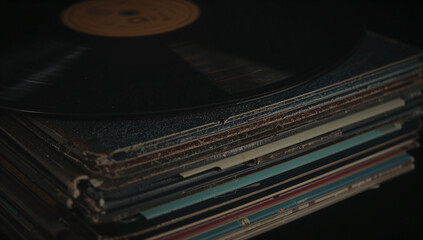 Fototapeta premium Discover the soulful warmth of vintage vinyl records stacked in a dimly lit studio, evoking nostalgia and timeless musical artistry.