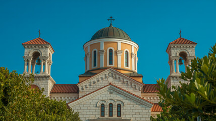 Fototapeta premium A daytime architectural photograph of a Byzantine-style church with light gray stone walls and terracotta-colored roof tiles.