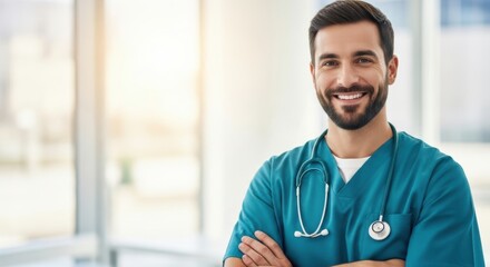 Smiling male healthcare professional with stethoscope and scrubs confidently looking at the camera in a bright hospital setting