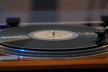 Vintage turntable spinning vinyl records with a warm, retro ambiance