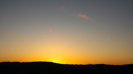 Sunset sky with orange glow and clouds