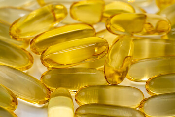 Golden Yellow Cod Liver Oil Gel Capsules on a Bright White Background