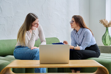 Young female patient during psychotherapy session with psychologist