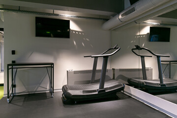 Modern gym with treadmills and exercise bikes