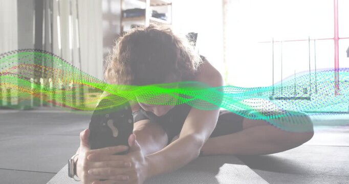Woman initiating hamstring stretching on mat for fitness tracking while animated metrics rising