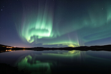 Vibrant Northern Lights Display: Green Sky Over a Dark Landscape