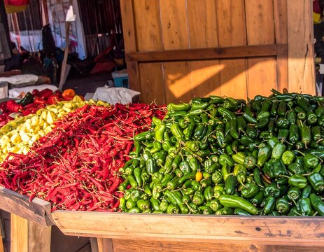 Fresh, vibrant piles of peppers at a market stall - Powered by Adobe