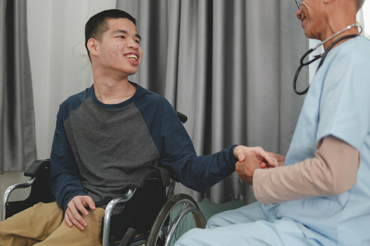 A young man with disability and a kind doctor encourage to patient in examination room, Activity in hospital , home, quarantine, Symptom monitoring and consultation by a specialist,Healthcare concept.