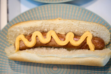 Hot dog with mustard on bun for fast food snack