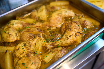 Chicken stew with potatoes serving on buffet