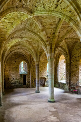 Historic Norman architecture with stone arches and columns inside a medieval abbey