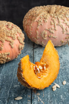 Galeux d Eysines Pumpkin Slice With Seeds On Rustic Table