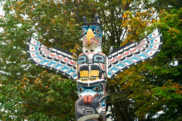 Stanley Park Totem in Autumn Leaves. Stanley Park totem pole with autumn leaves, Vancouver, British Columbia, Canada.
