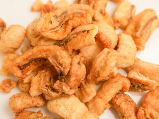 Crunchy banana chips on white background