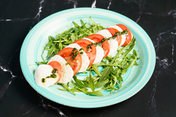 Caprese salad with mozzarella and arugula