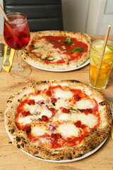 Spicy pizza and Aperol Spritz on wooden table