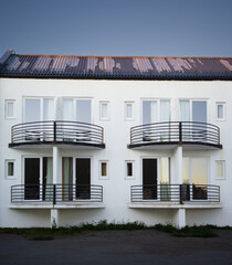 A facade of a building with windows and balcony on a hotel
