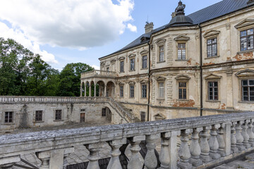 Fototapeta premium The facade of the old castle in summer
