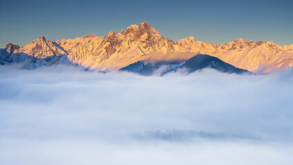 Mountain peak above sea of fog in winter