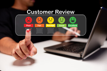A person giving a customer review online, using a feedback scale ranging from poor to excellent, while interacting with a laptop.