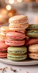 Fototapeta premium Stack of colorful macarons on a plate, soft focus background