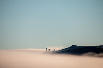 Mystical Landscape with Observatories Rising Above a Blanket of Morning Fog