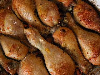 Roasted chicken drumsticks with golden crispy skin showing caramelized surface and juicy texture