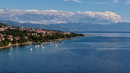 Fototapeta premium Aerial drone view of Crikvenica and Dramalj with turquoise Adriatic Sea, green-blue waters, beaches, and the island of Krk in the distance. Taken on 27.09.2025 in Dramalj, Croatia.