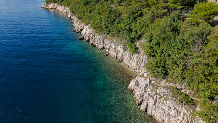 Aerial drone view of Crikvenica and Dramalj with turquoise Adriatic Sea, green-blue waters, beaches, and the island of Krk in the distance. Taken on 27.09.2025 in Dramalj, Croatia.