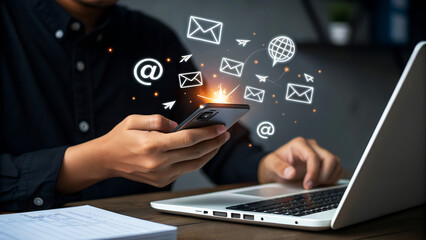 Businessman using smartphone and laptop for email marketing, newsletter, digital communication, and...