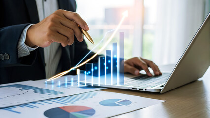Businessman analyzing companys financial growth strategy with laptop and data graph, planning for...