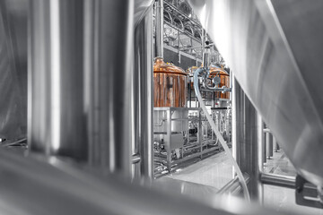 Industrial brewery equipment with large copper brewing tanks in modern brewery factory
