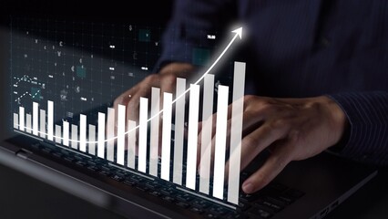 A professional person typing on a laptop with an overlay of data visualization showing financial growth, performance trends, and analytics in a modern workspace. Copula