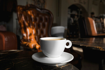 A cup of black coffee in a cafe with copy space