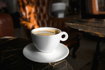 A cup of black coffee in a cafe with copy space