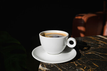 A cup of black coffee in a cafe with copy space