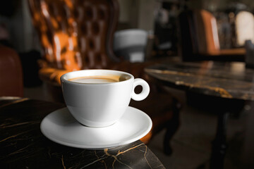 A cup of black coffee in a cafe with copy space