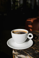 A cup of black coffee in a cafe with copy space