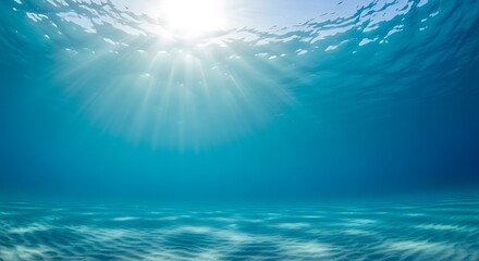 Fototapeta premium Sunbeams filtering through clear blue ocean water onto sandy seabed underwater