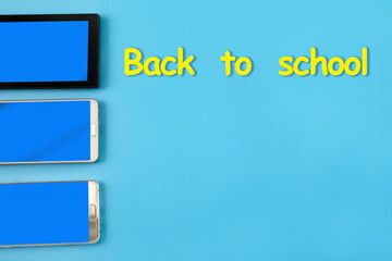 Back to school concept with mobile phone and tablet pc on blue background.