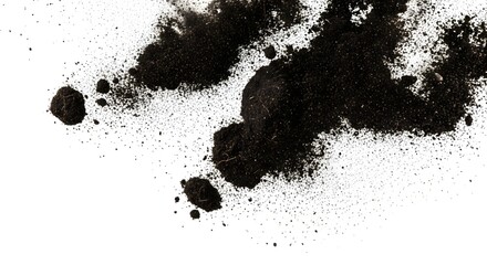Close up abstract macro view of dark soil particles and organic matter scattered on a stark white background creating a textured pattern