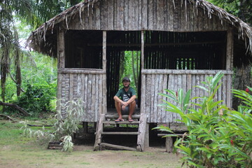 homem m frente a casa de palha no acre 