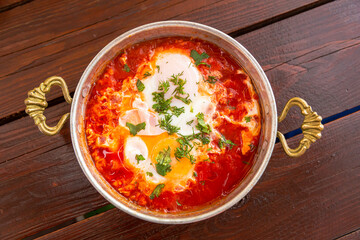 shakshuka with garlic and herbs in a small frying pan
