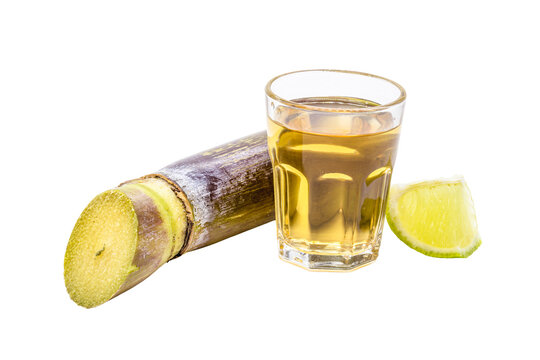 cacha&ccedil;a, distilled sugarcane alcohol drink, drink from Brazil, ranco Fundob isolated with piece of sugar cane next to it
