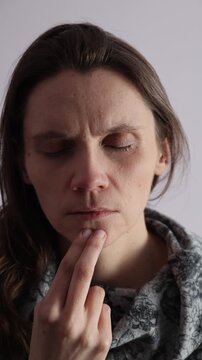 Female tapping EFT technique chin point on a face. Vertical video.