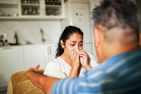 Couple having an emotional conversation at home