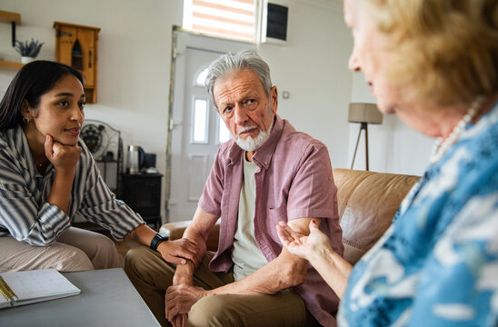Financial advisor helping a senior couple at home