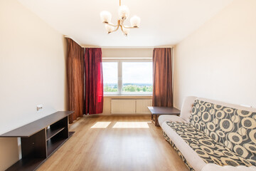Minimalism Bedroom Interior. Windows and Red Curtains. Sunlight. Hardwood Floor.