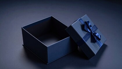Opened gift box with bow  ribbon on dark blue background.